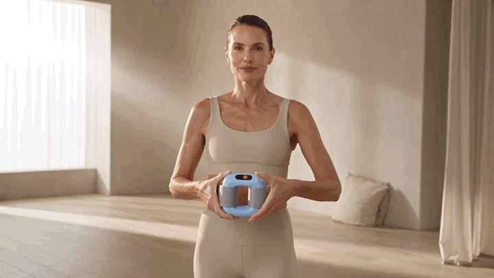 Woman presenting the Fascia Ring for an at-home body-care routine